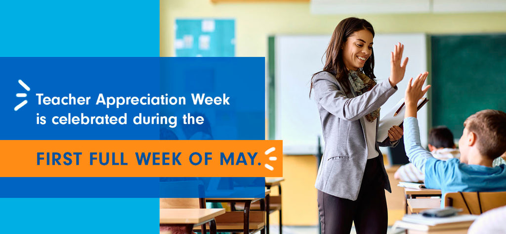 A teacher high fives a student in the classroom