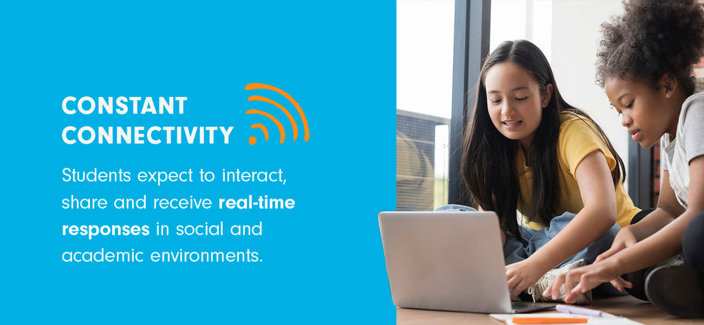 Two elementary school students use a laptop for school